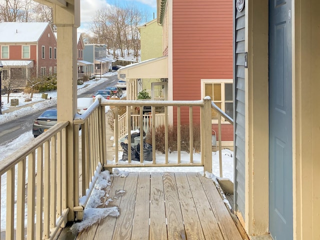 view of snow covered back of property