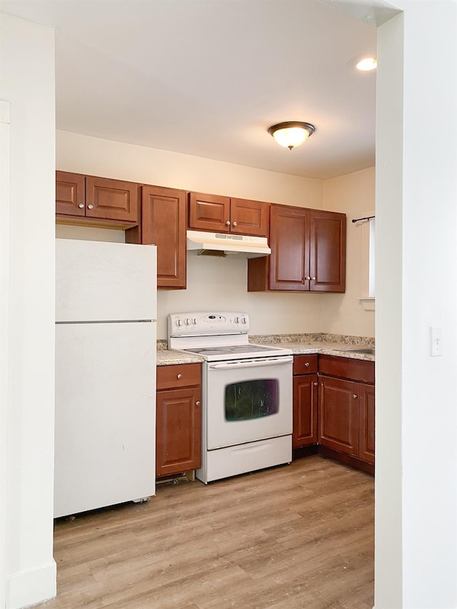 kitchen with white appliances and light wood-type flooring