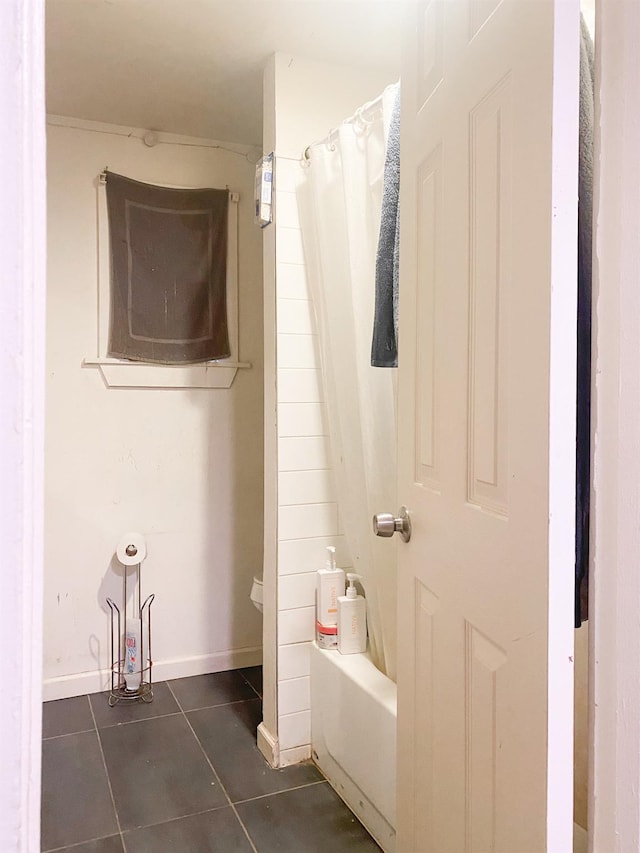 bathroom with shower / tub combo with curtain and tile patterned floors