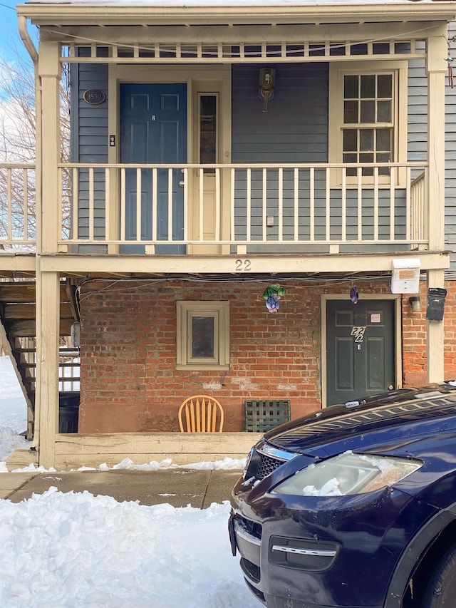 view of front of house with a porch and a balcony