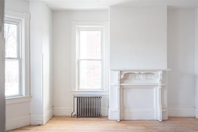 interior details with radiator heating unit and hardwood / wood-style floors