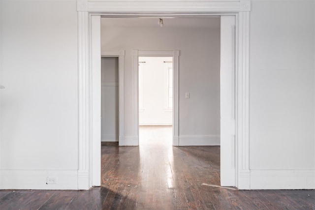 unfurnished room featuring dark wood-type flooring