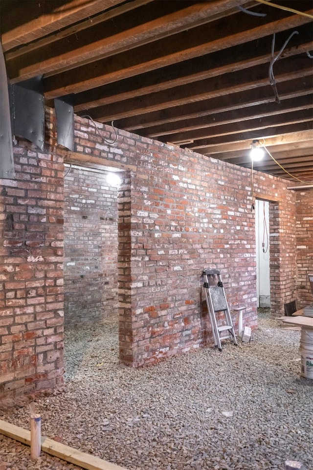 basement featuring brick wall