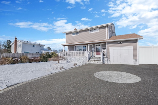 view of front of property with a garage and a porch