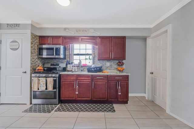 kitchen featuring tasteful backsplash, ornamental molding, stainless steel appliances, and light tile patterned floors