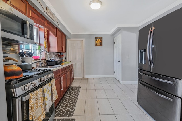 kitchen with light tile patterned floors, crown molding, sink, stainless steel appliances, and tasteful backsplash