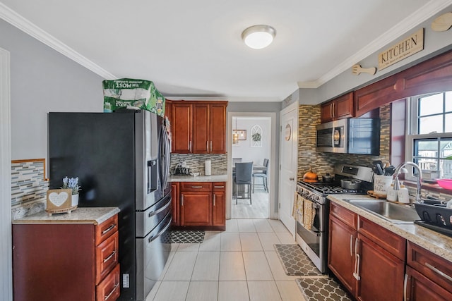 kitchen featuring sink, light tile patterned floors, ornamental molding, and appliances with stainless steel finishes