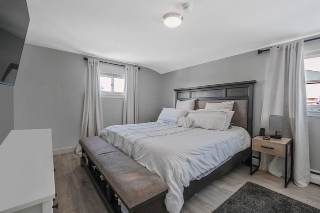 bedroom featuring a baseboard radiator and hardwood / wood-style floors