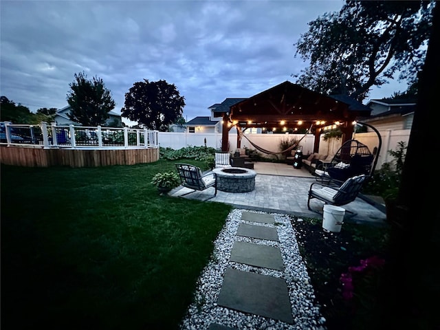 view of yard featuring a gazebo, a patio area, and an outdoor fire pit