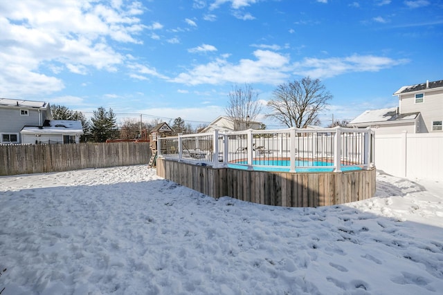 snowy yard with a fenced in pool