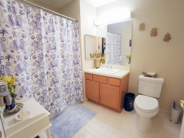 bathroom featuring vanity, tile patterned floors, and toilet