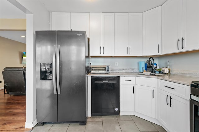 kitchen with white cabinetry, dishwasher, sink, and stainless steel fridge with ice dispenser