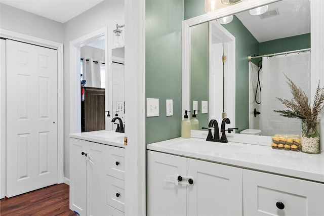 bathroom featuring vanity, curtained shower, and wood-type flooring