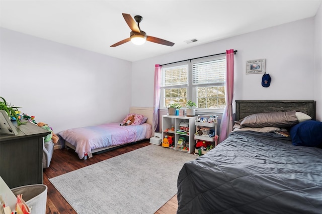 bedroom with ceiling fan and dark hardwood / wood-style floors