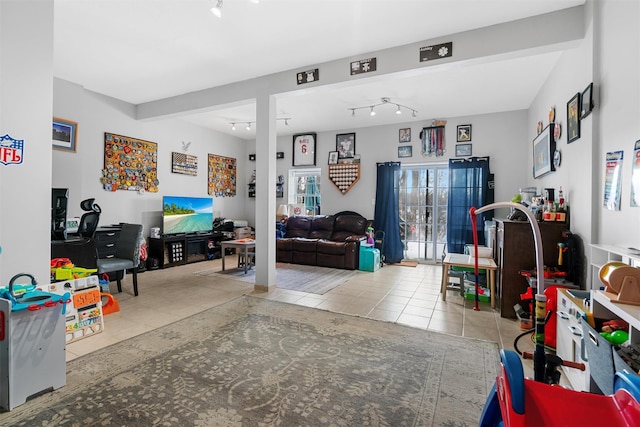 recreation room with rail lighting and light tile patterned floors