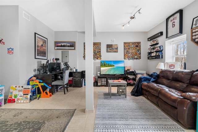 tiled living room featuring rail lighting and electric panel