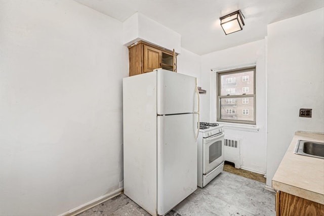 kitchen with white appliances and radiator heating unit