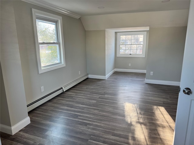 additional living space featuring baseboard heating, plenty of natural light, vaulted ceiling, and dark wood-type flooring