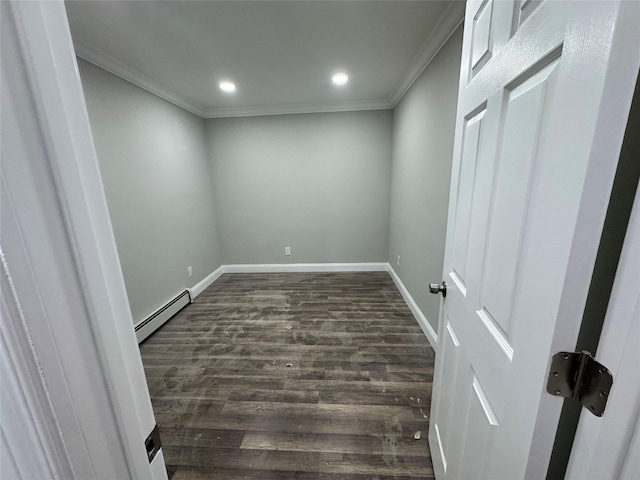 unfurnished room with dark wood-type flooring, a baseboard radiator, and ornamental molding