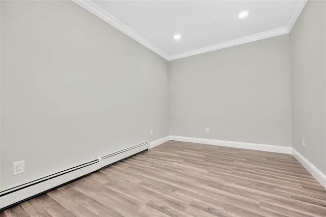 unfurnished room featuring baseboard heating, ornamental molding, and light hardwood / wood-style floors