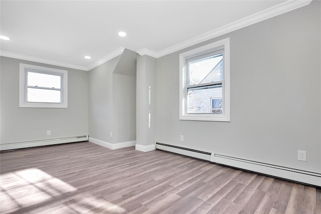 unfurnished room featuring baseboard heating, crown molding, and light hardwood / wood-style flooring