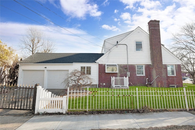 view of front of house with a front yard and a garage