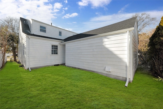 back of house featuring a lawn