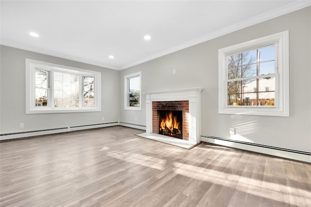 unfurnished living room featuring light hardwood / wood-style floors, crown molding, a brick fireplace, and a baseboard heating unit