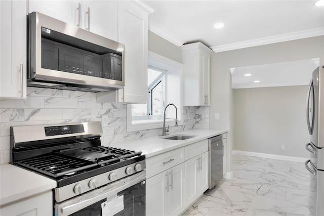 kitchen with sink, ornamental molding, appliances with stainless steel finishes, and white cabinets