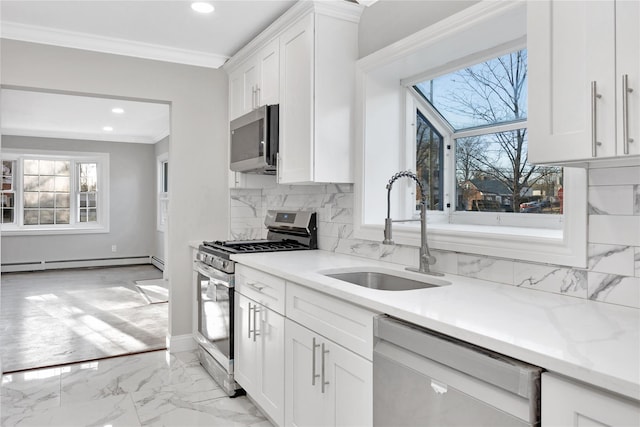 kitchen with white cabinets, appliances with stainless steel finishes, sink, and a baseboard radiator