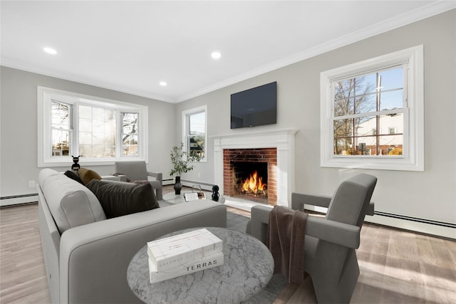 living room with light wood-type flooring, crown molding, a baseboard radiator, and a fireplace