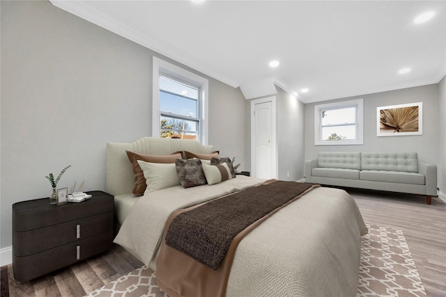 bedroom featuring light hardwood / wood-style flooring and crown molding