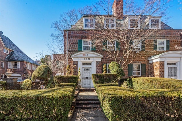 view of front of house featuring a high end roof and brick siding