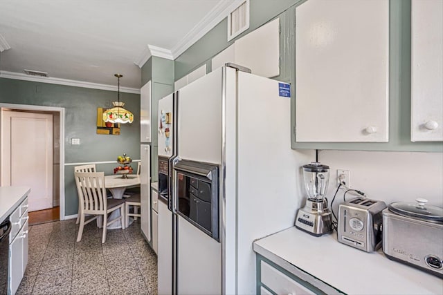 kitchen featuring white refrigerator with ice dispenser, visible vents, ornamental molding, decorative light fixtures, and granite finish floor