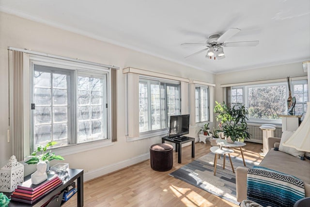 sunroom / solarium featuring a ceiling fan