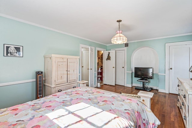 bedroom featuring dark wood-style floors, ornamental molding, and baseboards