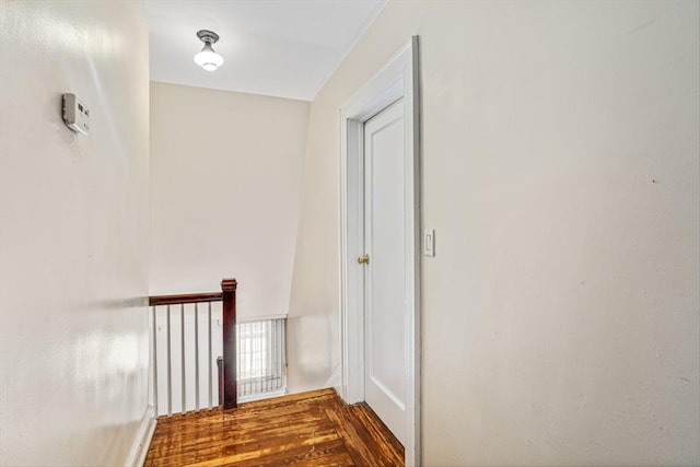 corridor with dark wood-style flooring