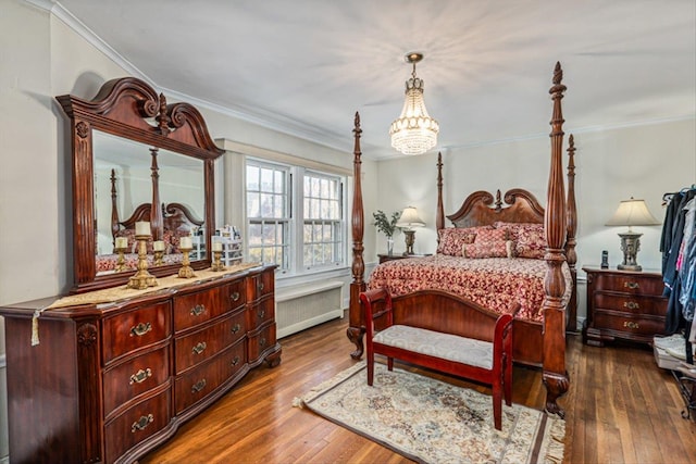 bedroom featuring radiator heating unit, dark wood finished floors, and crown molding