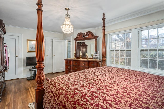 bedroom with dark wood finished floors, crown molding, and an inviting chandelier