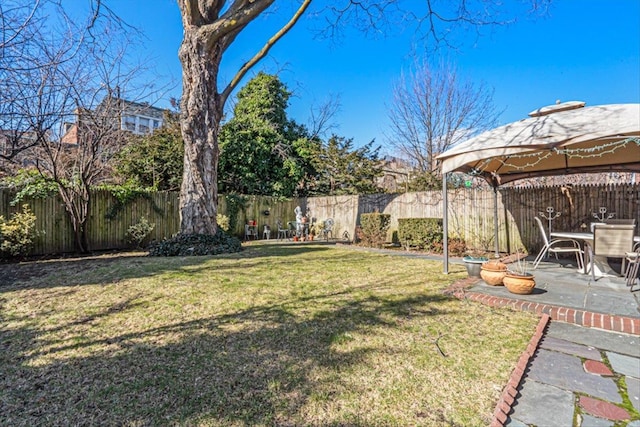 view of yard featuring a gazebo, a patio, and a fenced backyard