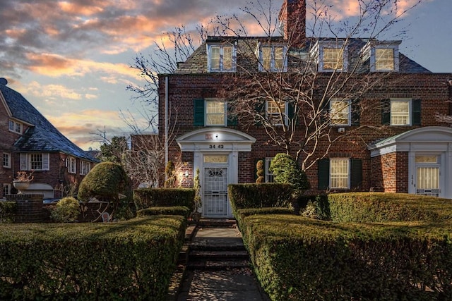 34-42 87th St, Jackson Heights, NY 11372 - view of front of home featuring brick siding and a chimney