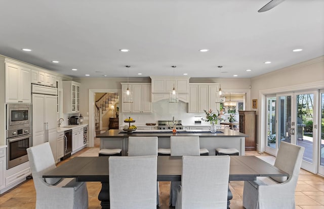 dining space featuring sink, light tile patterned floors, ornamental molding, and beverage cooler