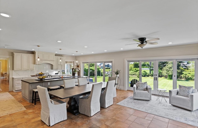 dining room with french doors, ceiling fan, and ornamental molding