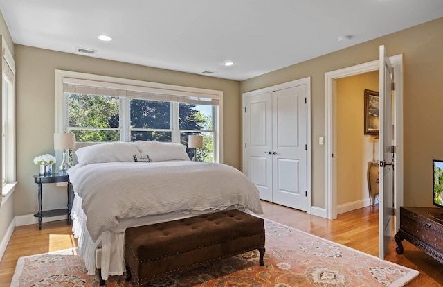 bedroom featuring a closet and light wood-type flooring