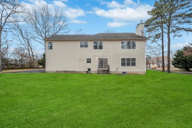 back of house with a lawn