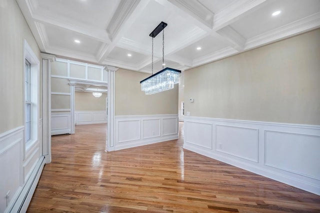 unfurnished dining area with a baseboard radiator, hardwood / wood-style flooring, coffered ceiling, crown molding, and beam ceiling