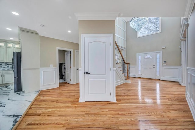 entrance foyer featuring washer and clothes dryer and light wood-type flooring