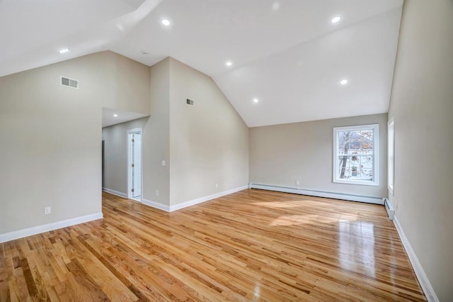 interior space with high vaulted ceiling, a baseboard heating unit, and light wood-type flooring