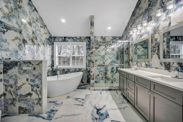 bathroom with lofted ceiling, vanity, plenty of natural light, and tile walls