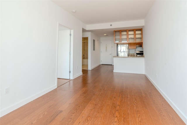 unfurnished living room with light hardwood / wood-style flooring and electric panel